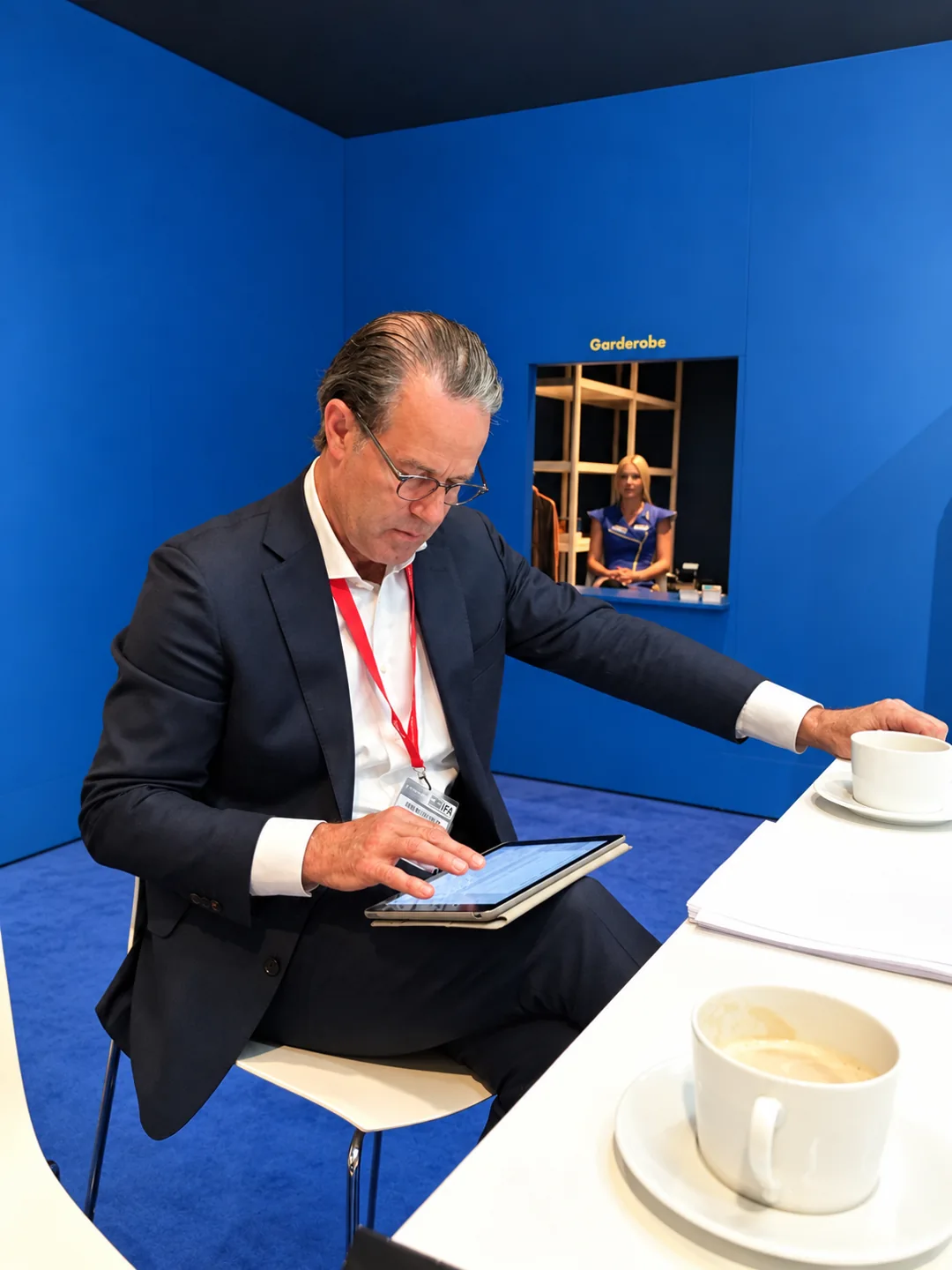David Goswick using a tablet at a technology exhibition.