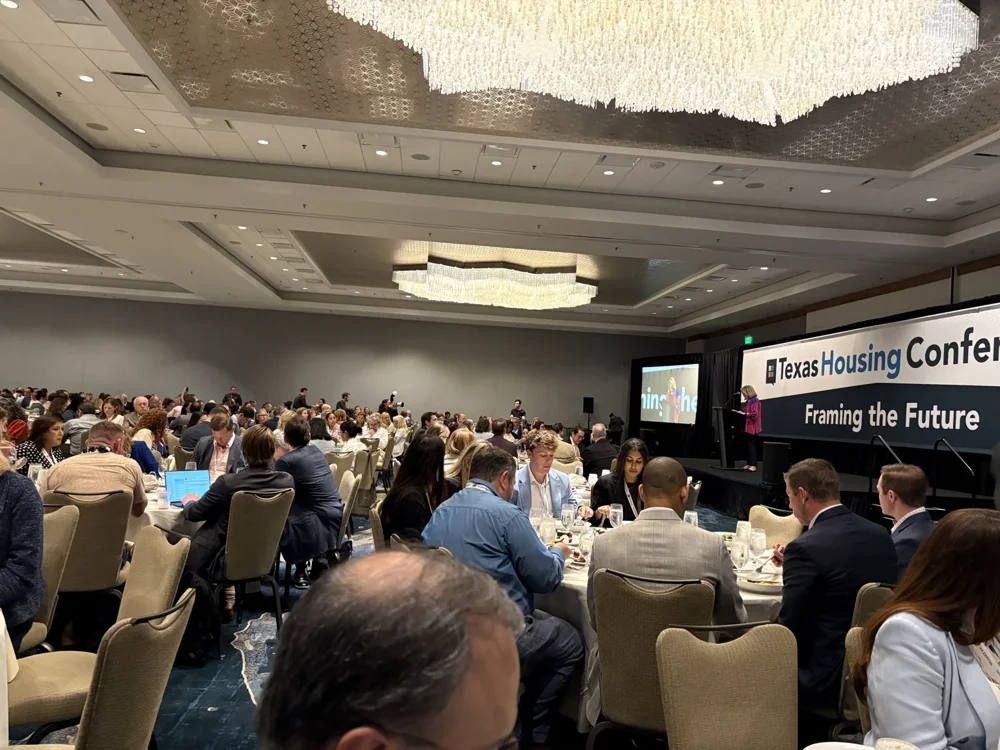 Attendees and a speaker at the Texas Housing Conference, with the theme Framing the Future.